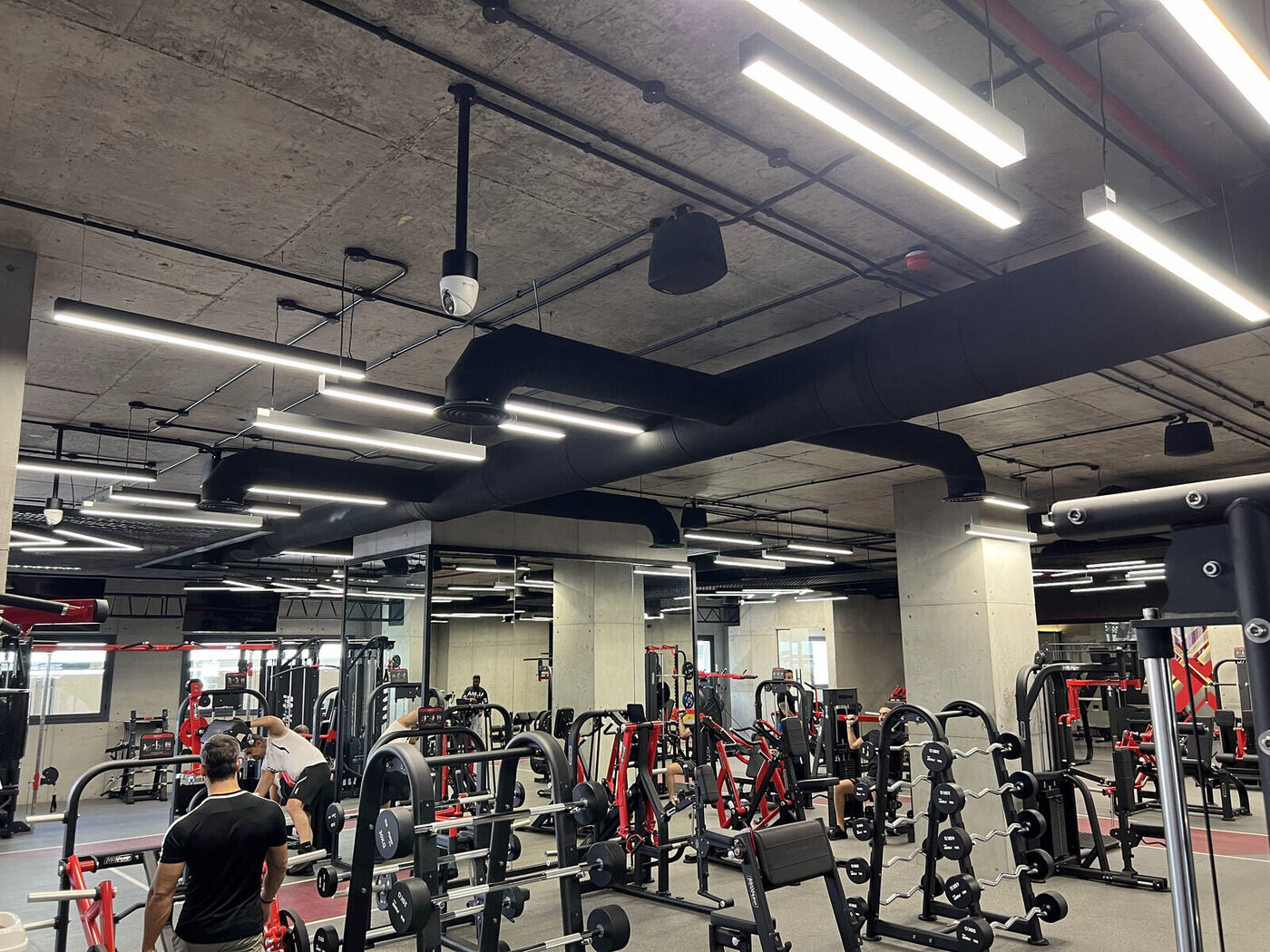 Exposed ductwork and lighting installed as part of a commercial gym fit-out in Jordan.