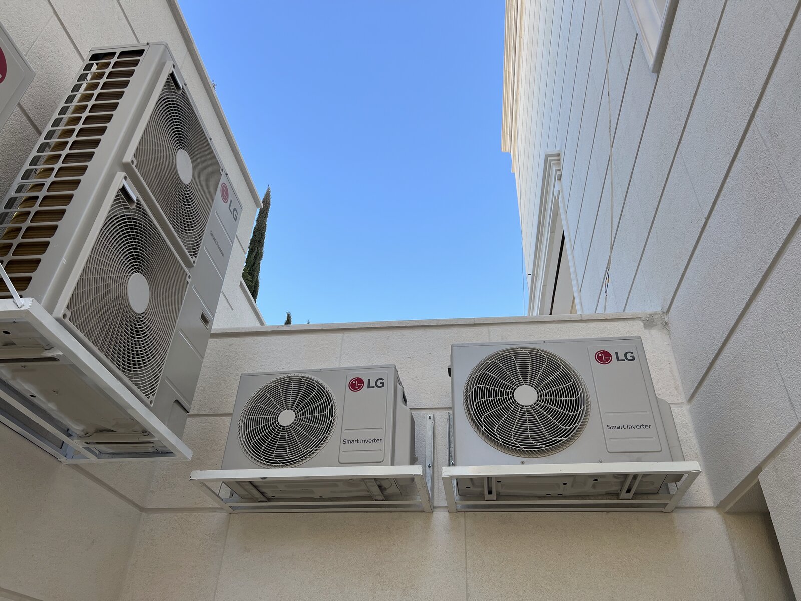 LG outdoor condenser units installed on a villa exterior wall